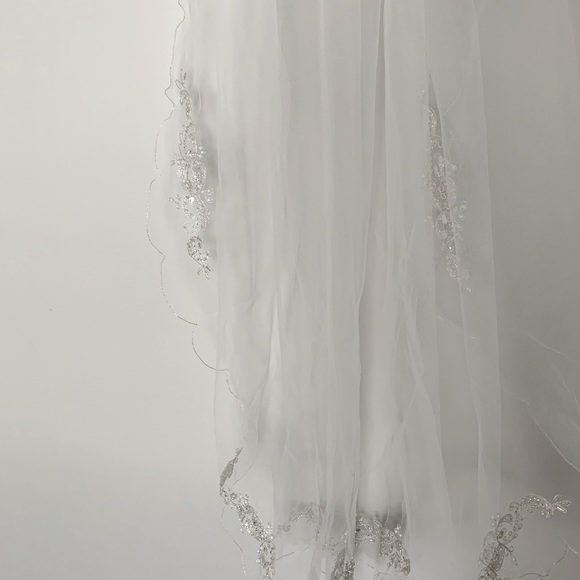 Never worn. Has been kept safety. Off shoulder
